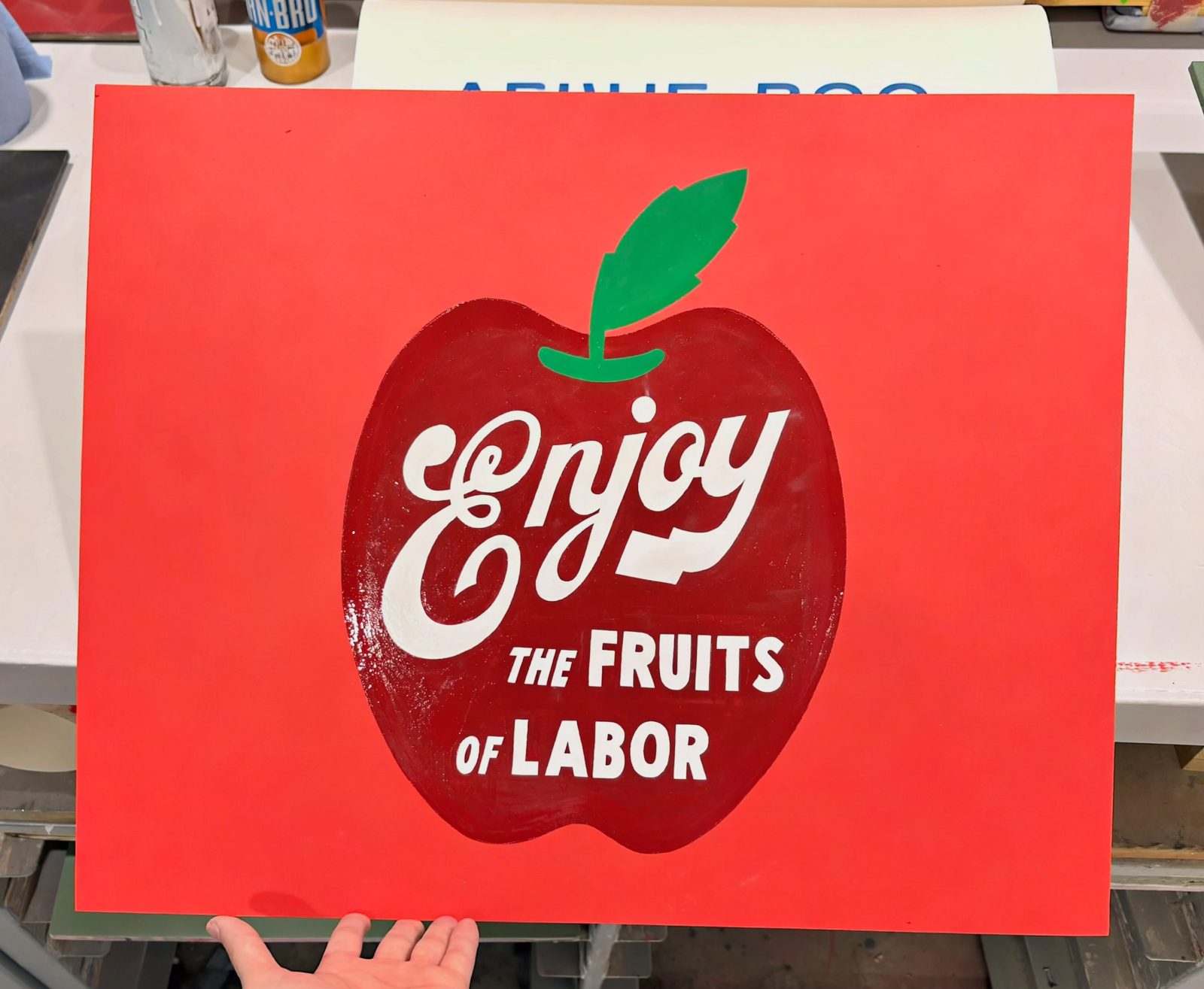 Hand-painted Enjoy the Fruits of Labor apple sign in red and white Hand-painted Enjoy the Fruits of Labor apple sign in red and white