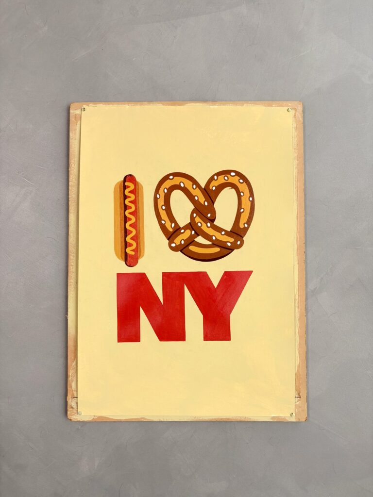 Finished I love NY board with a hot dog and pretzel on cream