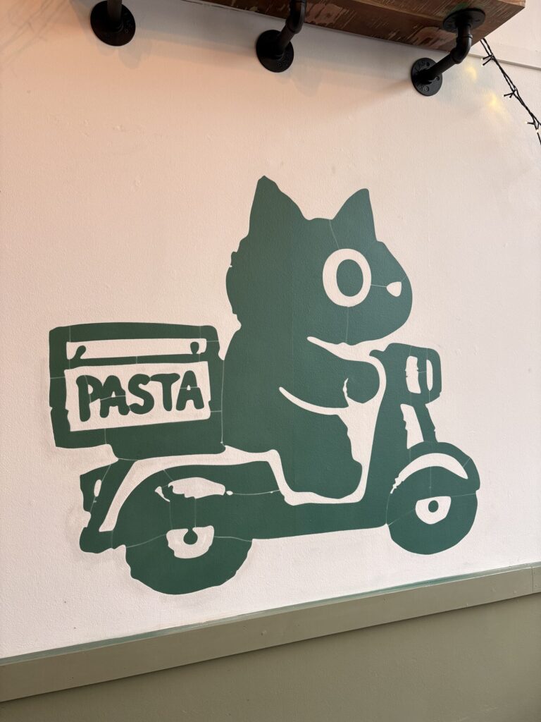Close-up of the hand-painted pasta delivery cat mural